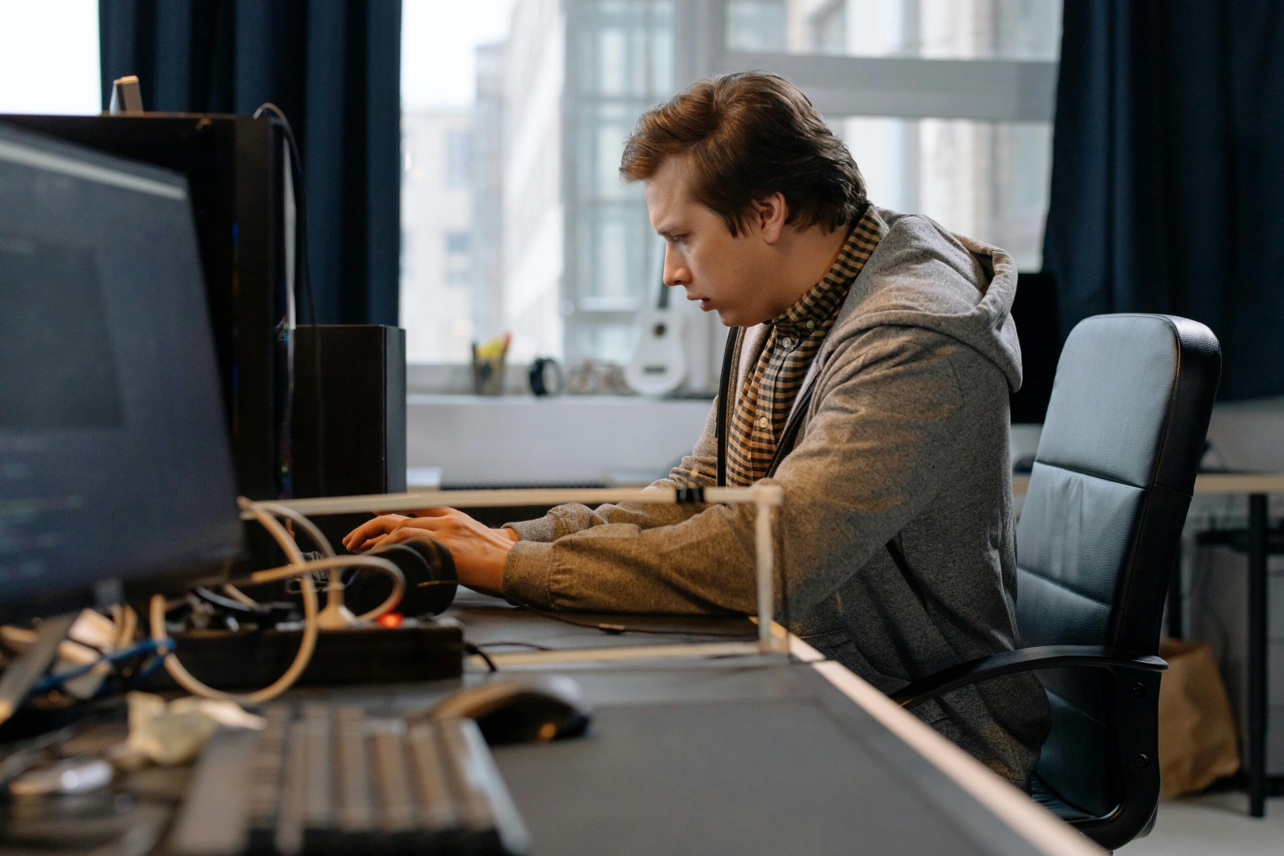pexels-cottonbro-6803531-scaled.jpg Free A concentrated professional working at a computer in a modern office setting. Stock Photo